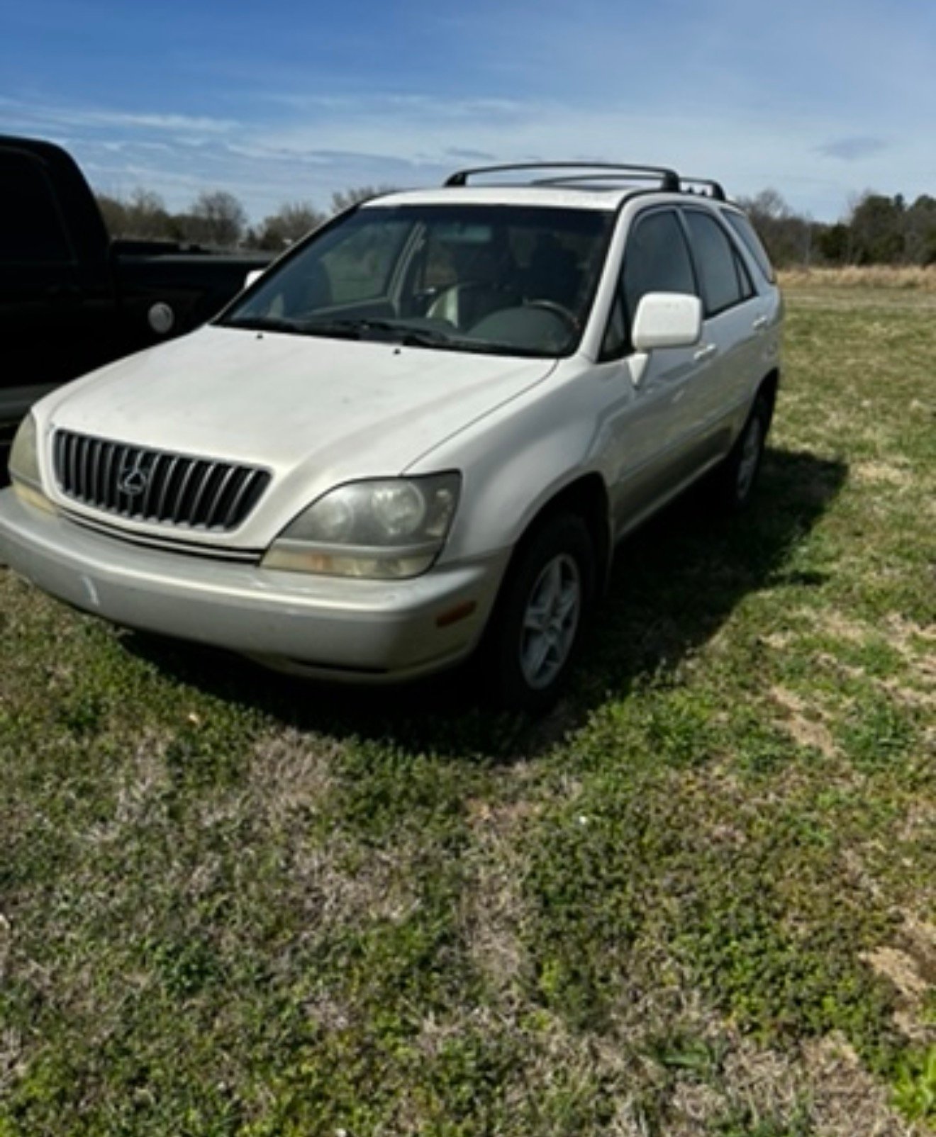 Older white Lexus SUV